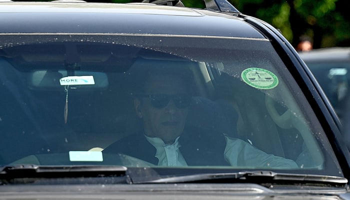 Pakistan´s former prime minister Imran Khan leaves from the High Court in Islamabad on June 12, 2023. — AFP