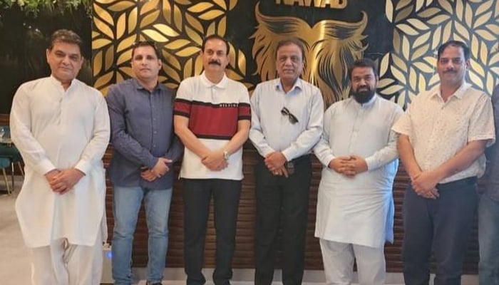 Former federal minister Babar Khan Ghauri (4th from left) in this group photo taken after a meeting in UAE. — photo by reporter