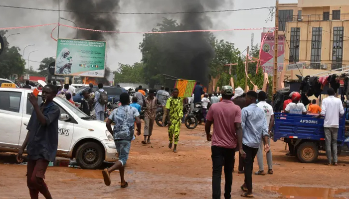 A general view of billowing smoke as supporters of the Nigerien defence and security forces attack the headquarters of the Nigerien Party for Democracy and Socialism, in Niamey on July 27, 2023. — AFP