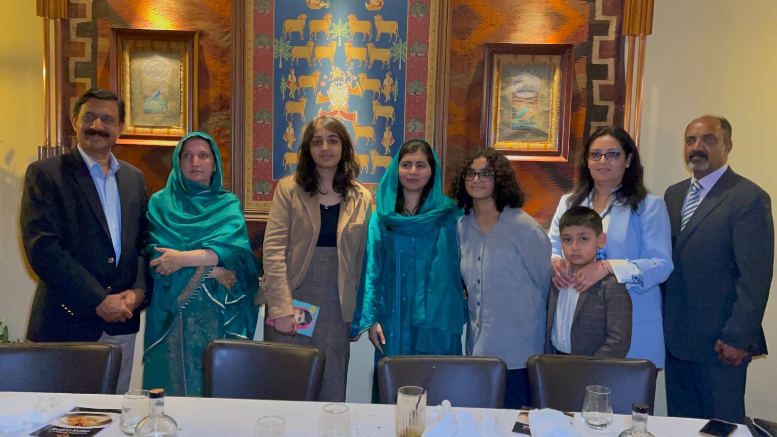 Nobel Peace Prize winner and education activist Malala Yousafzai (c) during a group photo with Pakistani Mahnoor Cheemas (C-L) family  who passed 34 GCSEs with A-stars, making a new UK and world record. — By the author