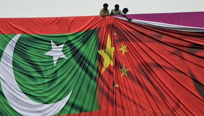 Flags of Pakistan (left) and China can be seen held by people. — AFP/File