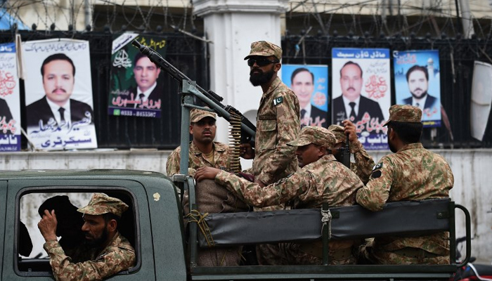 Pakistani soldiers patrol outside a voting material distribution center in Lahore. — AFP/File