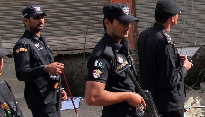 Police personnel stand guard in Peshawar. — AFP/File