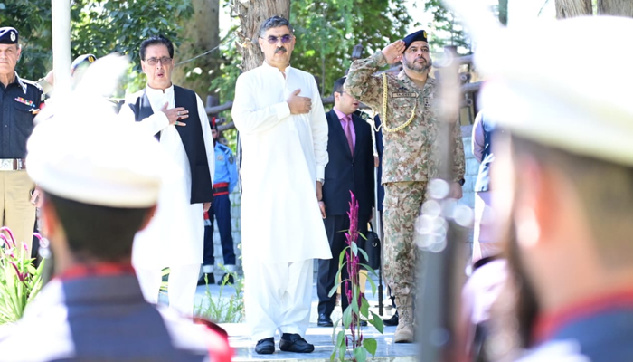 In this photograph released on September 12, 2023, shows Caretaker Prime Minister Anwaar-ul-Haq Kakar standing in honour before a grave while on his visit to Gilgit-Baltistan. — X/@PakPMO