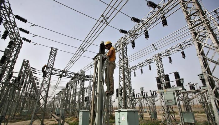 A representational image of a grid station where an electrician is busy working in Hyderabad. — APP/File