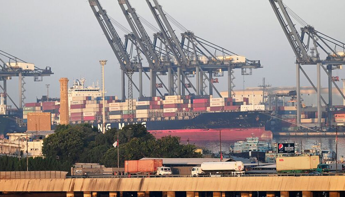 Shipping containers are seen stacked on a ship at a sea port in Karachi, Pakistan, on April 6, 2023. — AFP
