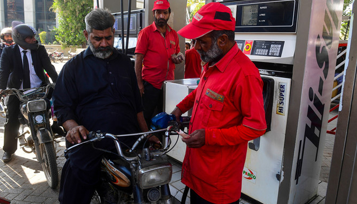 This picture taken on January 30, 2023, shows a man filling petrol in his motorcycle at a gasoline station in Pakistans port city of Karachi. — AFP