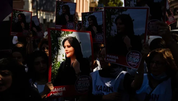 Protestors hold portraits of Mahsa Amini as they rally outside the Iranian consulate in Istanbul. — AFP/File