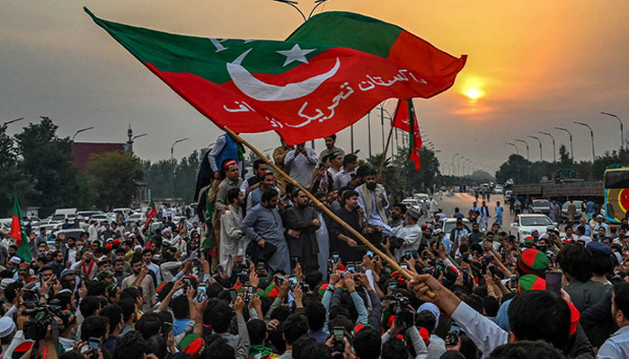 Supporters of Imran Khan, take part in a protest as they block the main road a day after the assassination attempt on Khan, in Peshawar on November 4, 2022. — AFP