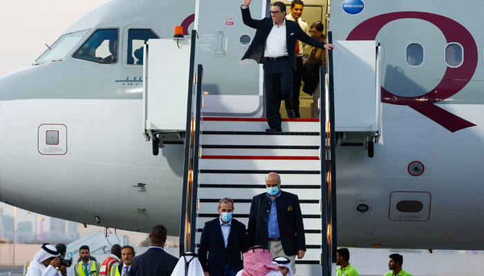 US citizens Siamak Namazi (C-back), Emad Sharqi (bottom-L) and Morad Tahbaz (bottom-R) disembark from Qatari jet upon their arrival at the Doha International Airport in Doha on September 18, 2023. — AFP
