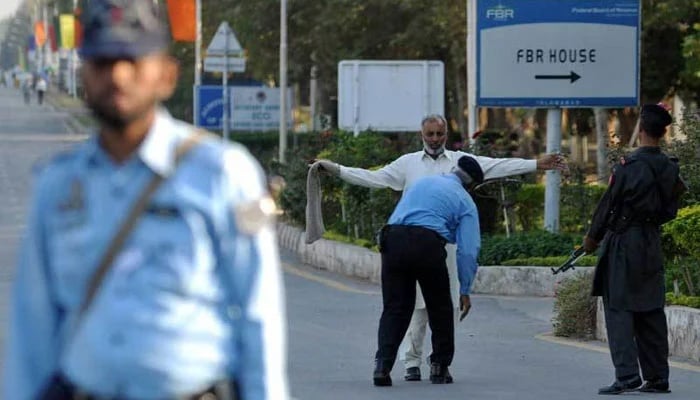 Islamabad police personnel checking a citizen amid tight security in the Federal capital. — AFP/File