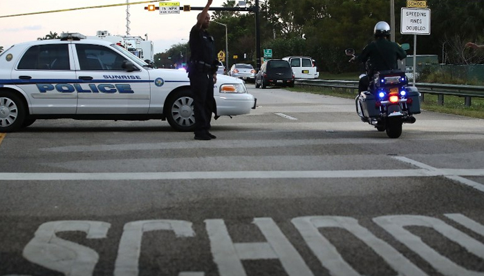 Police control a road at a crime scene in Parkland, Florida. — AFP/File