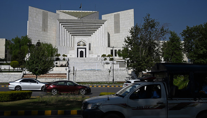 Motorists drive past Pakistans Supreme Court in Islamabad on April 5, 2022. — AFP