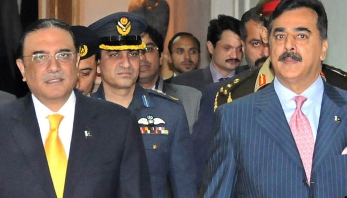 Former President Asif Ali Zardari (left) flanked by former Prime Minister Yousuf Raza Gilani in Islamabad. — AFP/File