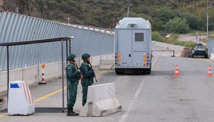 Azeri soldiers can be seen standing guard at the Lachin checkpoint on October 1, 2023. — AFP