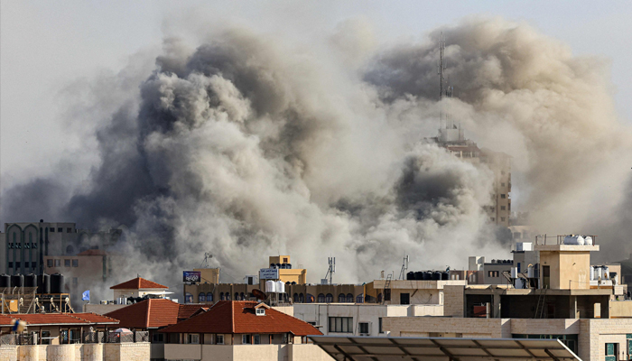 Smoke plumes rise over Gaza City on October 7, 2023, during Israeli air strikes. — AFP