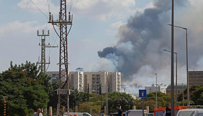 Smoke billows in Ashkelon on October 7, 2023, as barrages of rockets were fired from the Palestinian enclave into Israel. — AFP