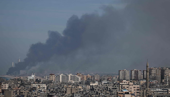 Smoke billows over the Israeli side of the border with Gaza as seen from Gaza City on October 7, 2023, following a series of early morning rocket attacks from the Gaza Strip into Israel. — AFP