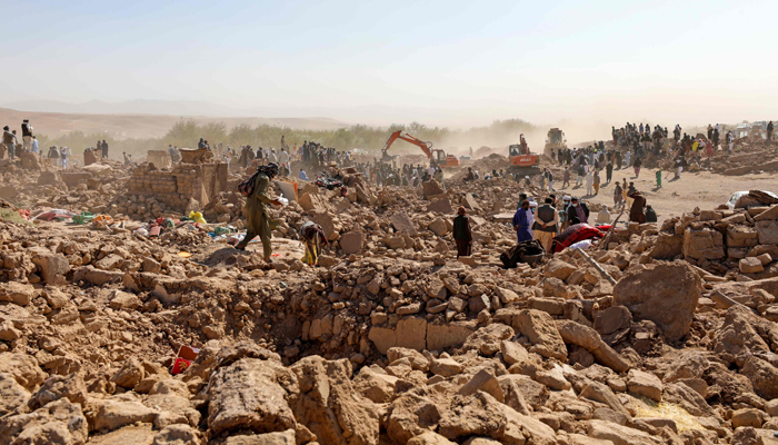 Afghan residents clear debris as they look for victims bodies in the rubble of damaged houses after the earthquakes in Siah Ab village, Zendeh Jan district of Herat province on October 8, 2023. — AFP