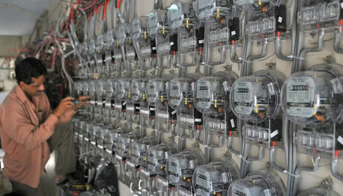 n electricity technician can be seen working on an electric meter. — AFP/File