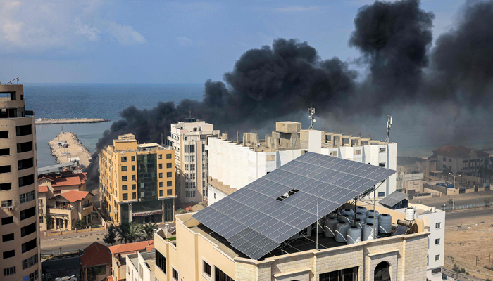 Smoke plumes billow following Israeli bombardment by the Gaza City seaport on October 11, 2023. — AFP