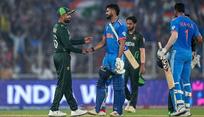 Shreyas Iyer (C) and KL Rahul (R) shake hands with Pakistans players at the end of the 2023 ICC Mens Cricket World Cup ODI match between India and Pakistan in Ahmedabad on October 14, 2023. — AFP