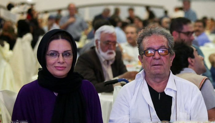 Iranian director Dariush Mehrjui and his wife, Vahideh Mohammadifar can be seen in a public gathering in this picture released on October 16, 2023. — X/@AFP