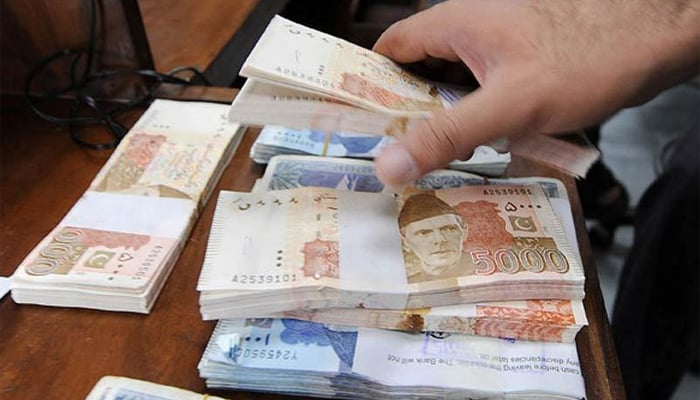 Stacks of Pakistani rupee notes. — AFP/File