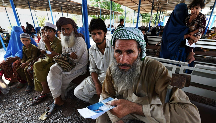 Afghan refugees wait to register at the UNHCR repatriation centre on the outskirts of Peshawar. — AFP/File