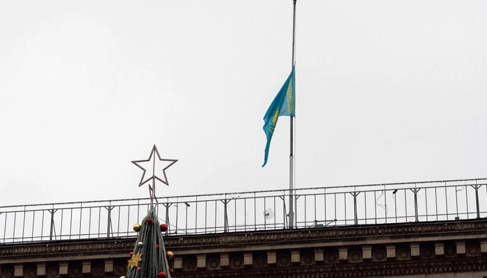 Kazakhstan state flag flies at half-mast on the roof of an administrative building in central Almaty. — AFP/File