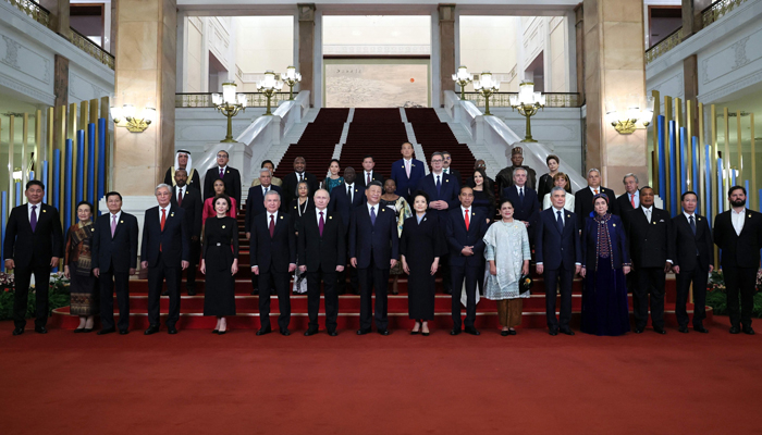 This photograph shows Russias President Vladimir Putin, Chinese President Xi Jinping and his wife Peng Liyuan pose for a photo with heads of delegations participating in the Third Belt and Road Forum in Beijing on October 17, 2023. — AFP