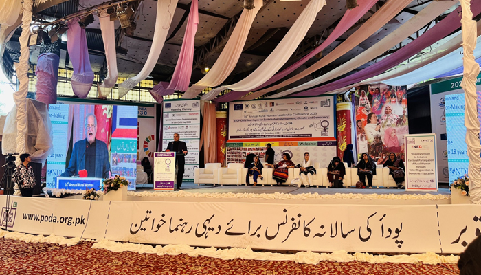 16th Annual Rural Women Leadership Conference in session with penalises sitting on the stage on the 3rd Day of the conference, with Zafarullah Khan speaking on October 17, 2023. — Facebook/PODA-Pakistan