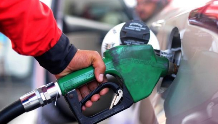 A person can be seen refilling in a car. — AFP/File