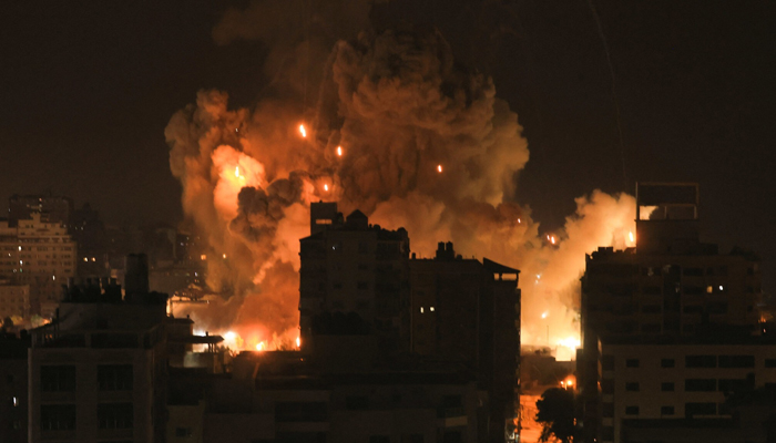Fire and smoke rise above buildings in Gaza City during an Israeli airstrike on October 8, 2023. — AFP