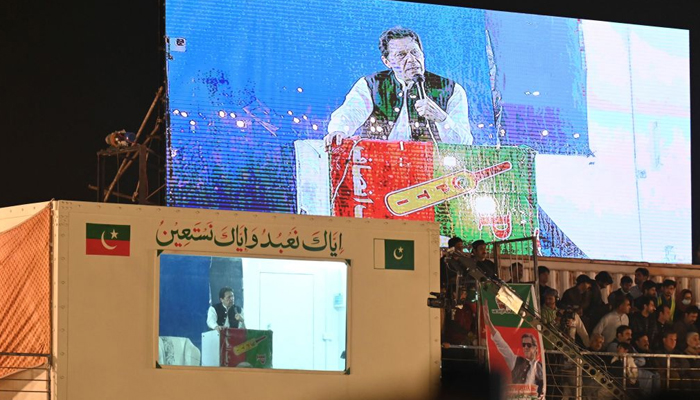 Former Pakistan PM Imran Khan addresses his supporters from behind a bulletproof screen. — AFP/File
