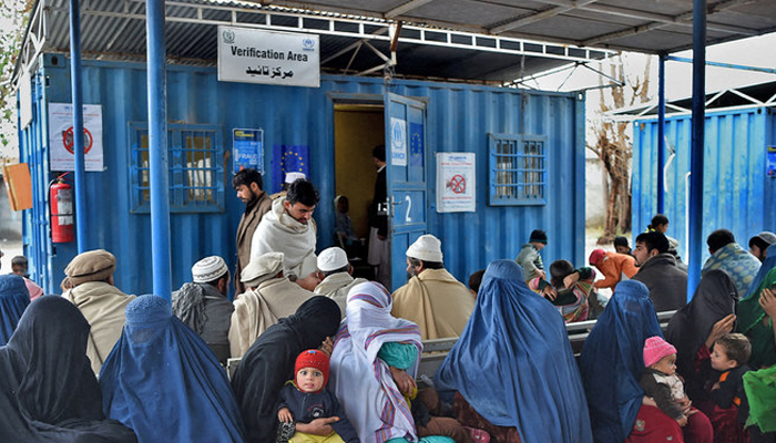 Afghan refugees wait to update their family data at the UNHCR Verification Center in Chamkani, on the outskirts of Peshawar. — AFP/File