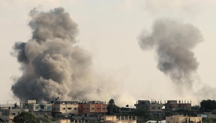 Smoke billows over Gazas Rafah border crossing with Egypt an Israeli airstrike on October 10, 2023. — AFP