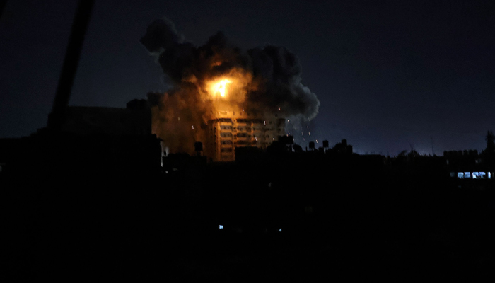 Smoke and fire billow from a building after an explosion in Rafah, South Gaza Strip on October 19, 2023. — AFP