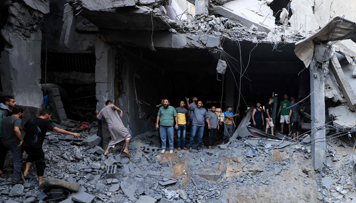Palestinians look for survivors in the rubble of a building hit during Israeli bombardment in Khan Yunis on the southern Gaza Strip on October 19, 2023. — AFP