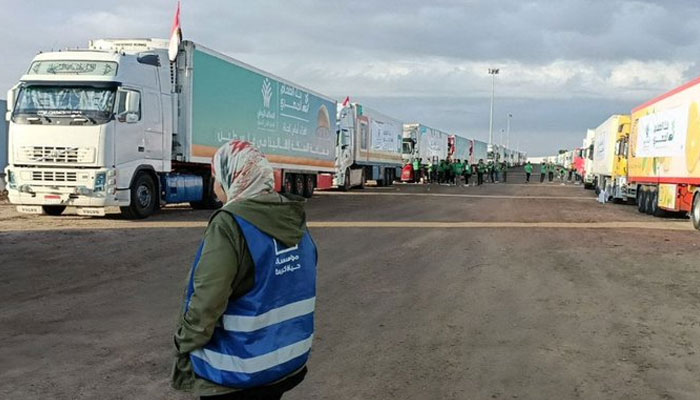 Trucks carrying vital humanitarian supplies for blockaded Gaza Strip line up at Rafah border crossing with Egypt after key agreement to allow some aid reached. Daily Sabah