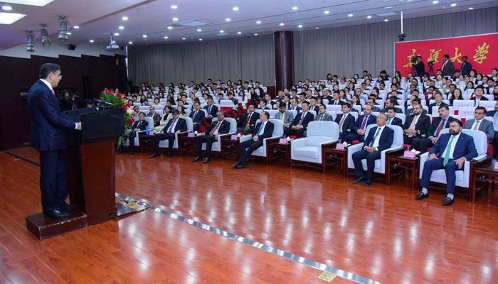 Caretaker Prime Minister Anwaar-ul-Haq Kakar addresses the faculty and students of Xingjian University on October 20, 2023. — PID