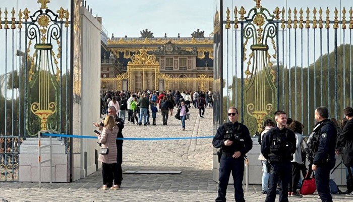 French police stand guard in front of the Chateau de Versailles as tourists enter again after the Palace was evacuated for security reasons, in Versailles, near Paris, France, October 17, 2023. AFP