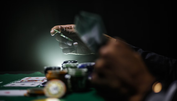 A representational image of a gambling table with people making bets. — Unsplash/File