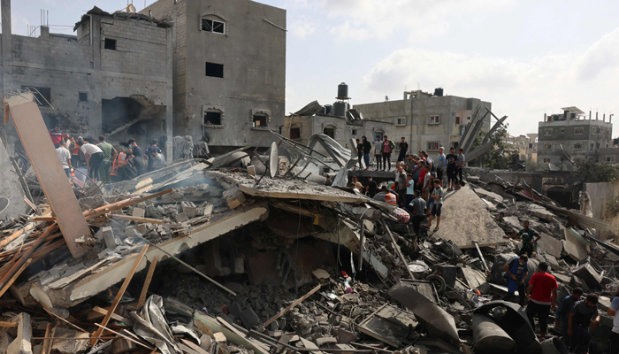 Palestinians inspect the rubble after an Israeli strike on Rafah in the southern Gaza Strip on October 22, 2023. — AFP