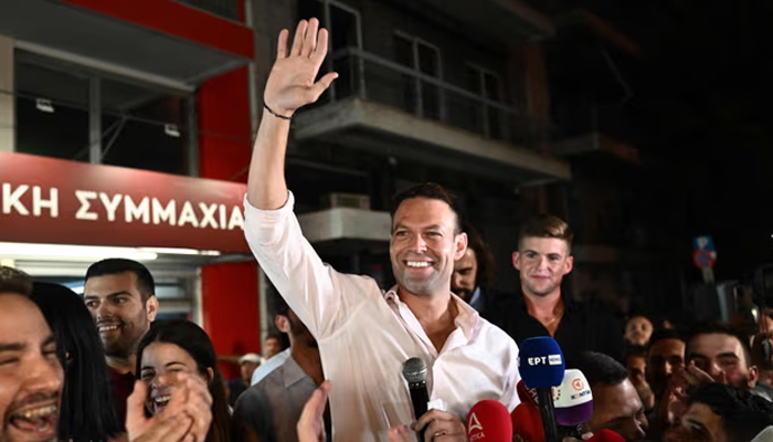 Stefanos Kasselakis waves to supporters outside Syriza’s headquarters in Athens after being elected party leader. — AFP/File