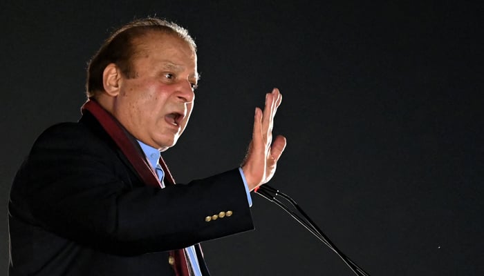 Former Prime Minister Nawaz Sharif addresses his supporters gathered at a park during an event held to welcome him in Lahore on October 21, 2023. — AFP