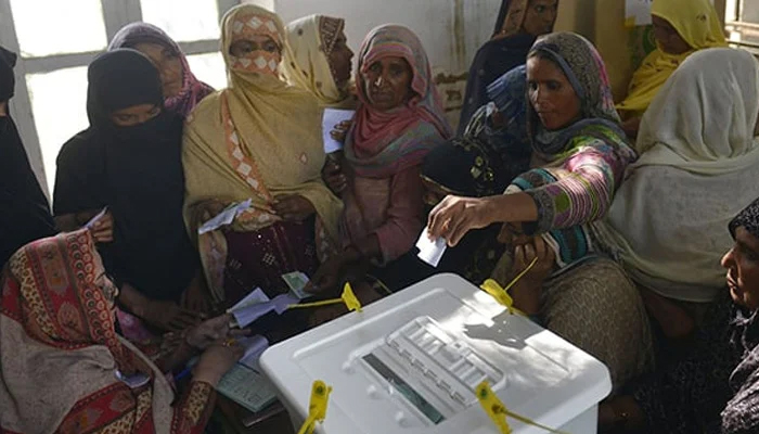 A voter casting a ballot during a local government election at a polling station in Lahore. — AFP/File
