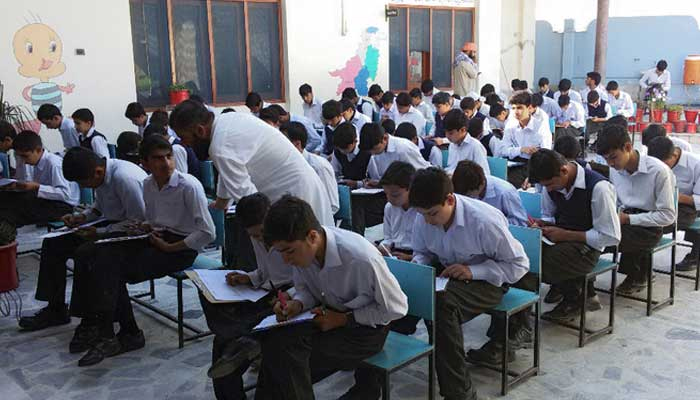 Students can be seen attempting an exam. — AFP/File