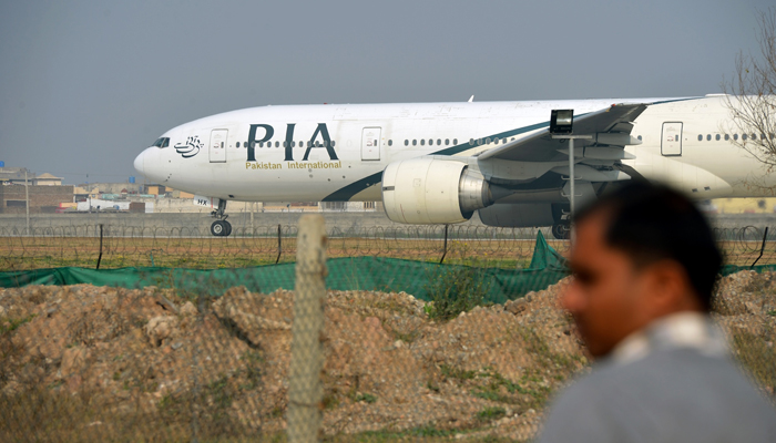 Pakistan International Airlines (PIA) aeroplane can be seen on a runway in an airport. — AFP/File
