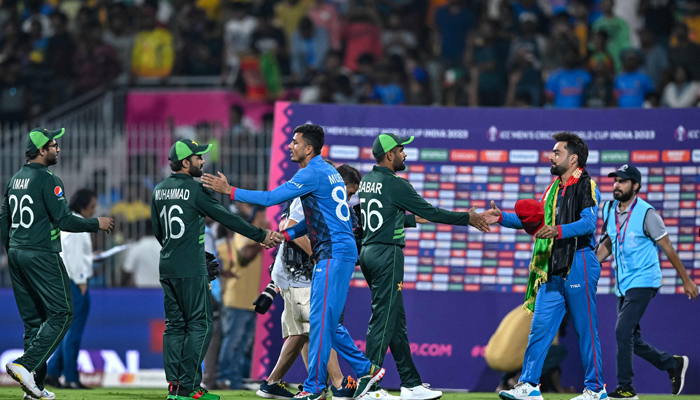 Afghanistans and Pakistans players greet each other at the end of the 2023 ICC Cricket World Cup one-day international (ODI) match at the MA Chidambaram Stadium in Chennai on October 23, 2023. — AFP